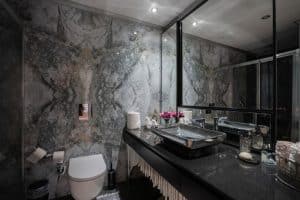 Dark and modern bathroom with black and silver color