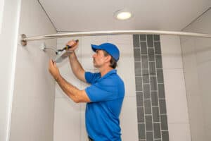 Plumber installing showerhead